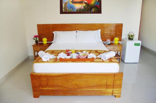 a bedroom with a bed with stuffed animals on it at Del Castillo Plaza Hotel Pucallpa in Pucallpa
