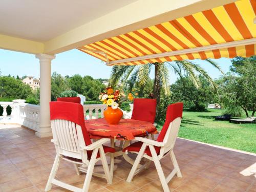 a table and chairs under an umbrella on a patio at Holiday Home Montemar by Interhome in Fanadix