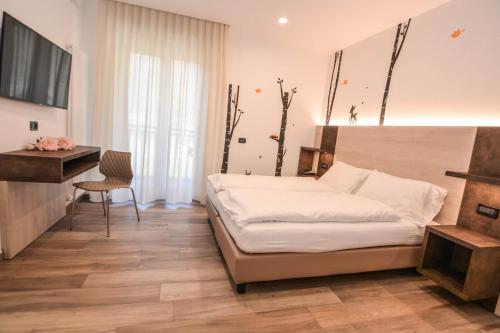 Postel nebo postele na pokoji v ubytování ALPieve Albergo Pieve