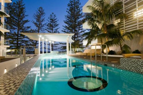 a swimming pool on the side of a building at Rumba Beach Resort in Caloundra