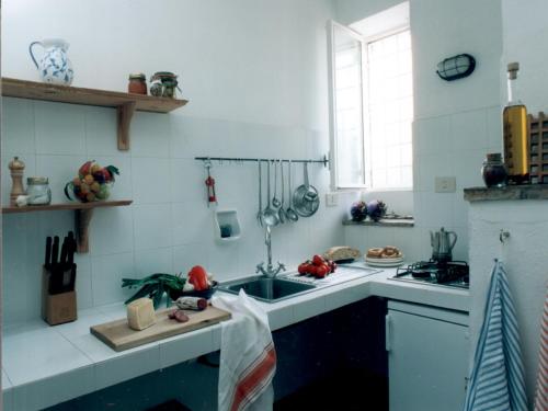 a kitchen with a sink and a stove at Vignagrande Agriturismo in Saturnia
