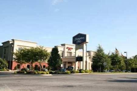 a building with a sign on the side of a street at Hampton Inn Elkton in Elkton