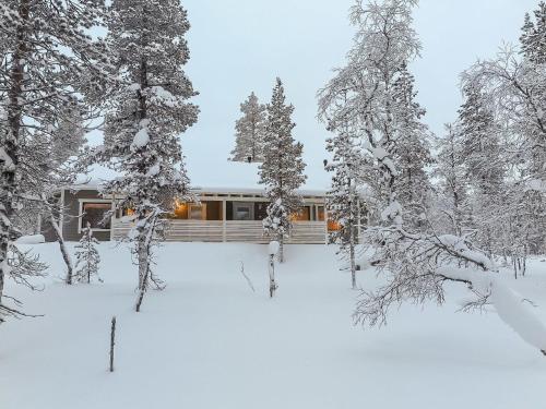 a house in the snow with snow covered trees at Holiday Home Hilla a by Interhome in Saariselka
