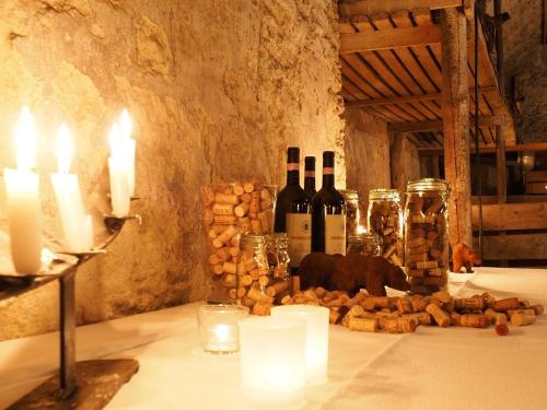 a table with candles and bottles of wine and bread at Landgasthof Bären in Madiswil