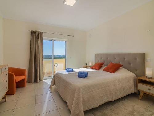 a bedroom with a bed with a view of the ocean at Holiday Home Vila Caravela by Interhome in Estevais