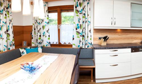 a kitchen with a wooden table and a counter at Ferienhaus Meissnitzer in Haus im Ennstal