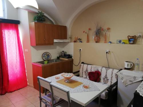 a kitchen with a table and a table and a couch at Mantilaria in Fira