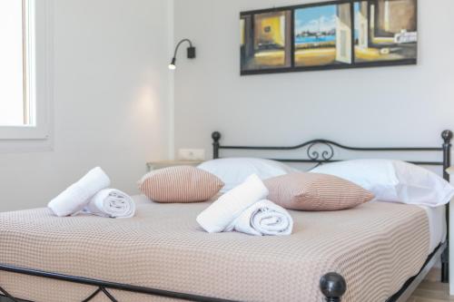 a bed with towels and pillows on it at Naxos Illusion Nikos Verikokos in Naxos Chora