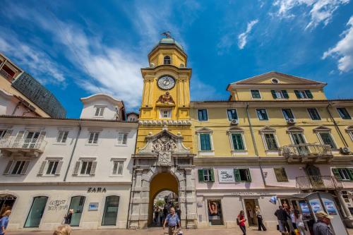 a building with a clock tower on top of it at Deluxe Ploech in Rijeka