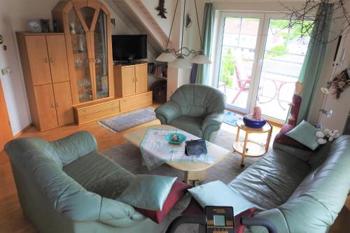 a living room with a couch and a table at Maison Christa in Bad Kissingen