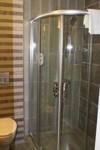 a shower stall in a bathroom with a toilet at LİMAN BOUTIQUE OTEL in Kemer