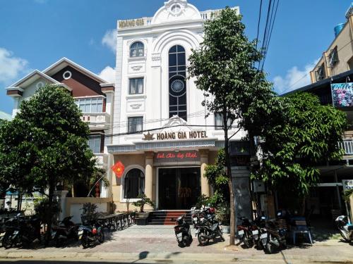 a white building with motorcycles parked in front of it at Hoàng Gia Hotel Côn Đảo in Con Dao