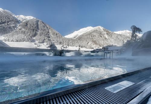 a large body of water surrounded by mountains at Sport- und Genusshotel Silvretta in Ischgl