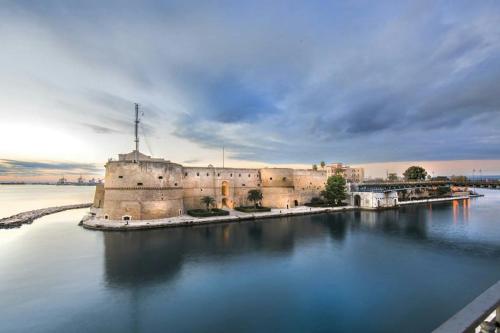 a castle in the middle of a body of water at Villa A DUE PASSI DAL MARE in Taranto