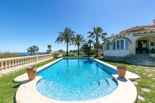 a swimming pool in front of a house at Villa Montgo Denia in Denia