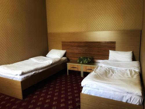 a hotel room with two beds and a table at Park House Taldykorgan in Taldykorgan