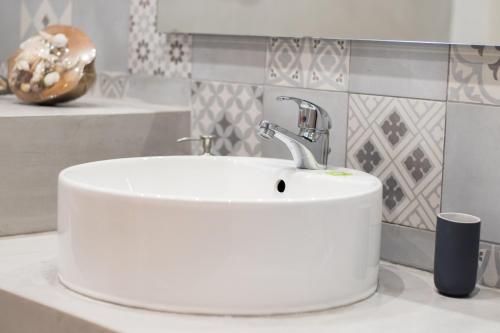 a white sink on a counter in a bathroom at Finiki Studios in Karpathos Town