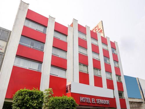 a red hotel building with a hotel e saragency sign at Hotel El Senador in Mexico City