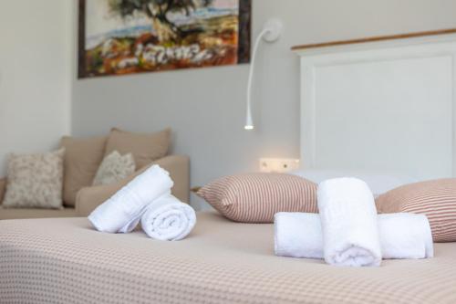 a bed with rolled towels on top of it at Naxos Illusion Nikos Verikokos in Naxos Chora