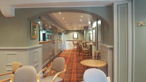 a row of chairs and tables in a room at Castle Oaks House Hotel in Limerick