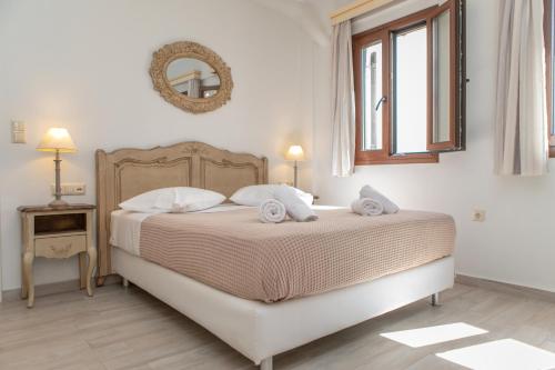 a bedroom with a bed and a mirror on the wall at Naxos Illusion Nikos Verikokos in Naxos Chora