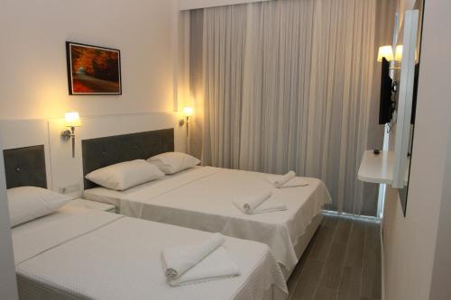 A bed or beds in a room at LİMAN BOUTIQUE OTEL