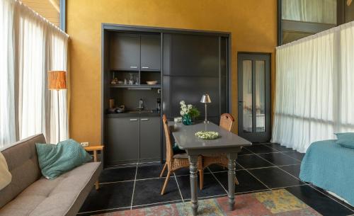 a living room with a table and a couch at Bed and Breakfast Batenborg in Winsum