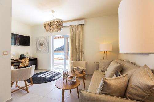 a living room with a couch and a table at Nostos Beach Boutique Hotel in Balíon