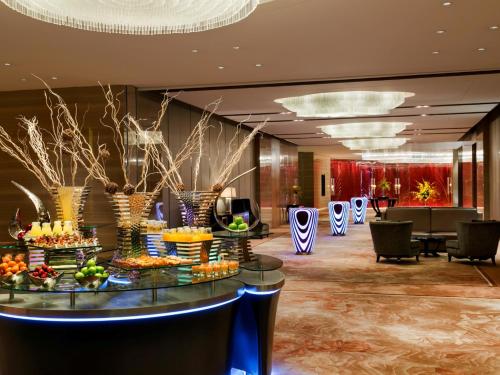 a lobby with a table with food on it at Kempinski Hotel Xiamen in Xiamen