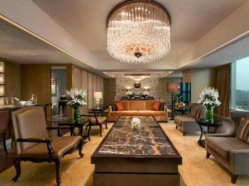 a living room with a chandelier at Kempinski Hotel Xiamen in Xiamen