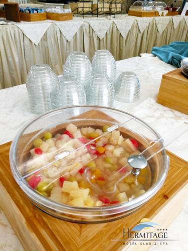 a bowl of food sitting on a wooden table at Hermitage Hotel in Silvi Marina