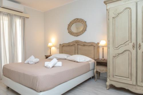 a bedroom with a bed with two towels on it at Naxos Illusion Nikos Verikokos in Naxos Chora