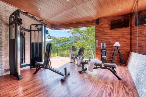 a gym with treadmills and exercise equipment in a house at The Inn at Palo Alto in Boquete