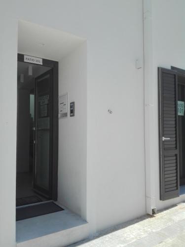 a white building with an open door on the side at Patio 101 "Exclusive" in San Vito lo Capo