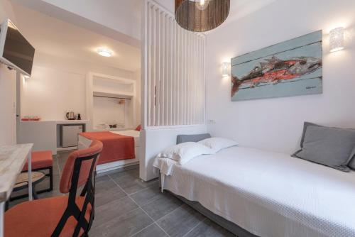 a hotel room with a bed and a dining room at Black Coast Santorini in Perivolos