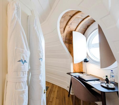 a room with a desk and a window and a surfboard at The Albatroz Hotel in Cascais