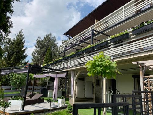 a house with an outdoor patio with an umbrella at Kwaterka in Brenna