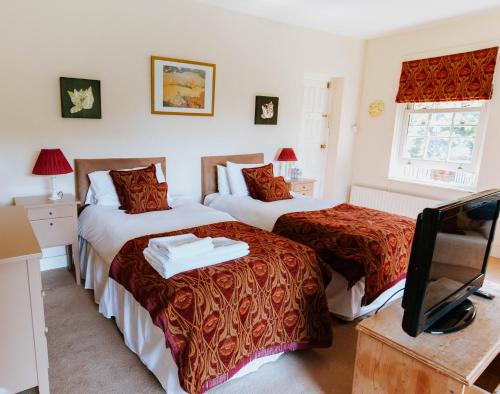 Un pat sau paturi într-o cameră la Bluebell House