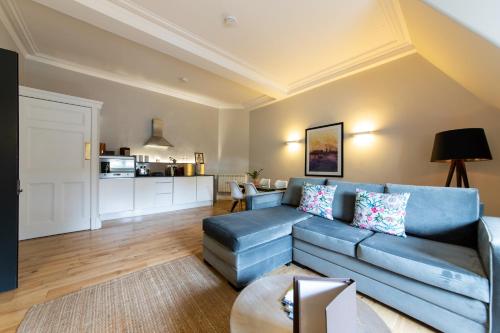 a living room filled with furniture and a couch at Linton Collection - 28 North Bridge in Edinburgh