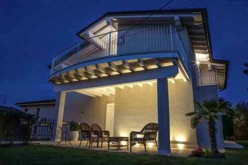 a view of a house with a deck at night at Casa Speri in Peschiera del Garda