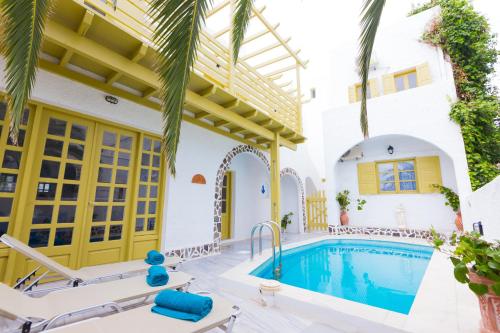 a villa with a swimming pool and a house at Sunny Days in Fira