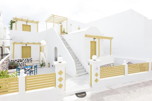 a room with a staircase leading up to a balcony at Sunny Days in Fira