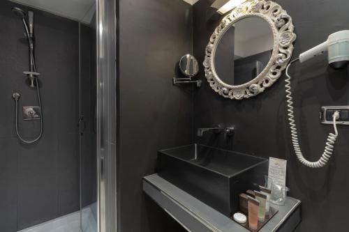 a bathroom with a sink and a mirror at Hotel Columbia Wellness & Spa in Montecatini Terme