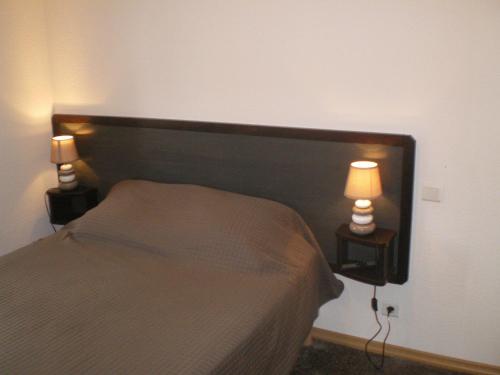 Postel nebo postele na pokoji v ubytování L'Auberge Fleurie
