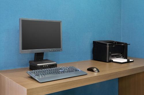 a computer monitor and a keyboard and mouse on a desk at Days Inn by Wyndham Saint John in Saint John