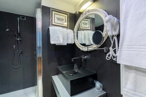 a bathroom with a sink and a mirror at Hotel Columbia Wellness & Spa in Montecatini Terme