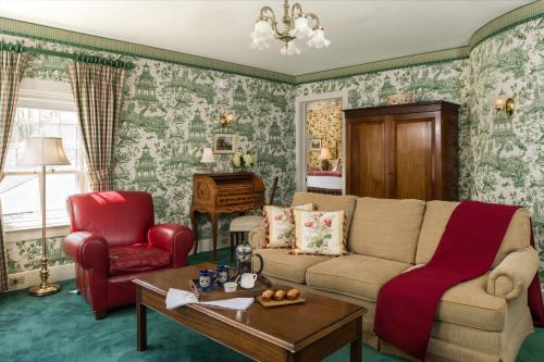 a living room with a couch and a chair at The INN at Ormsby Hill in Manchester