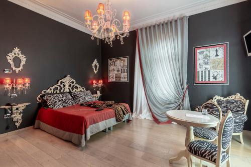 a bedroom with a bed and a chandelier at Hotel Columbia Wellness & Spa in Montecatini Terme
