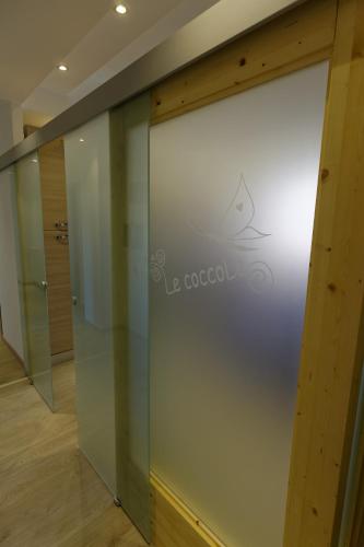 a sliding glass door with a logo on it at Le Coccole in La Spezia
