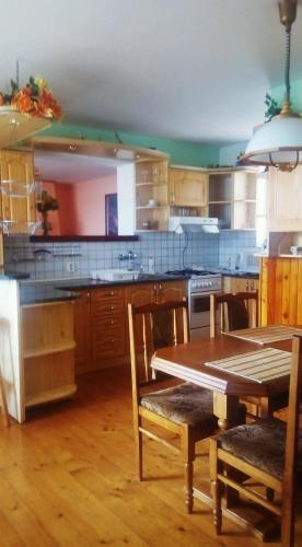 a kitchen with a table and chairs and a table and a tableablish at Ladislav in Spišské Vlachy